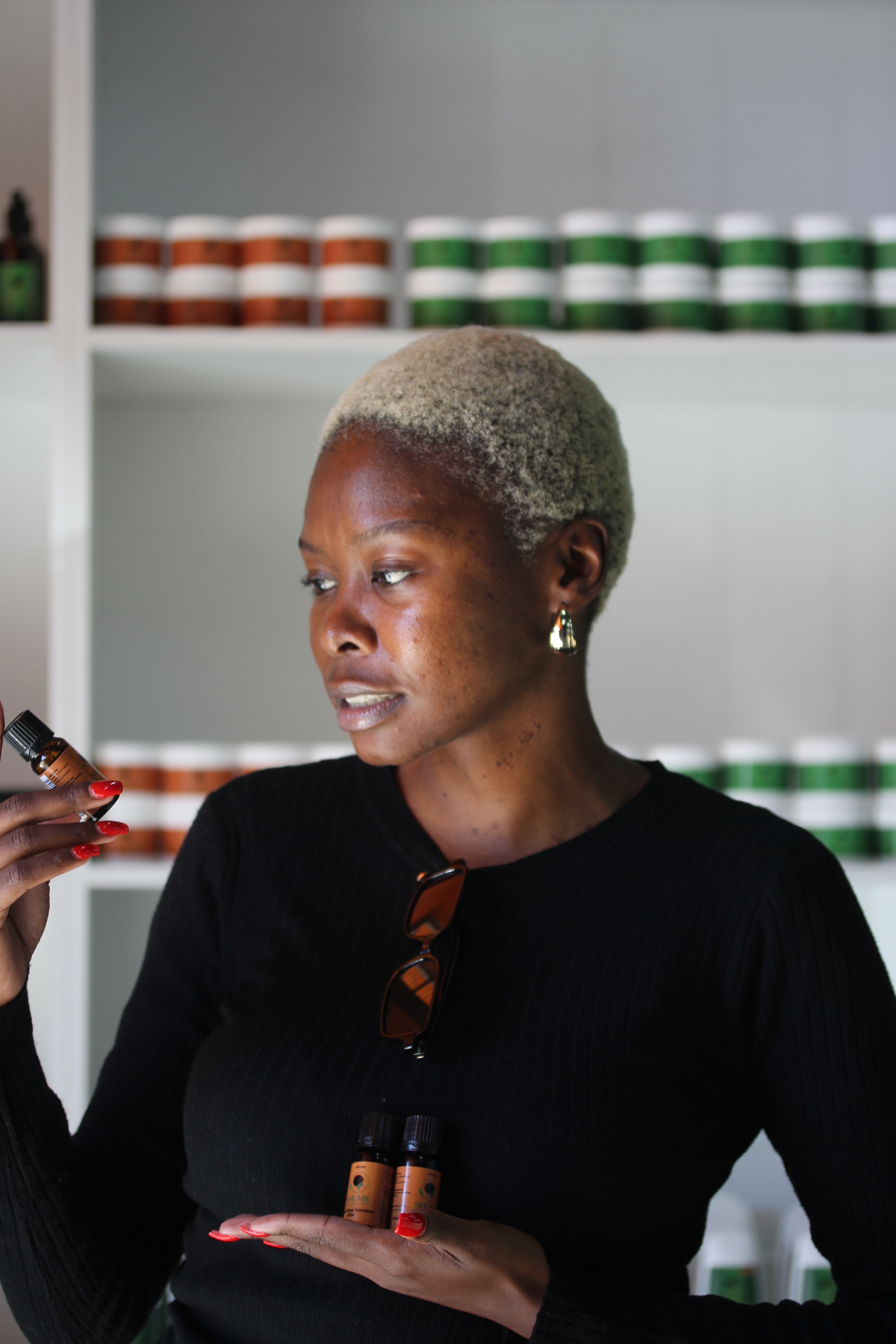 Shumie hairline care held beside natural hair