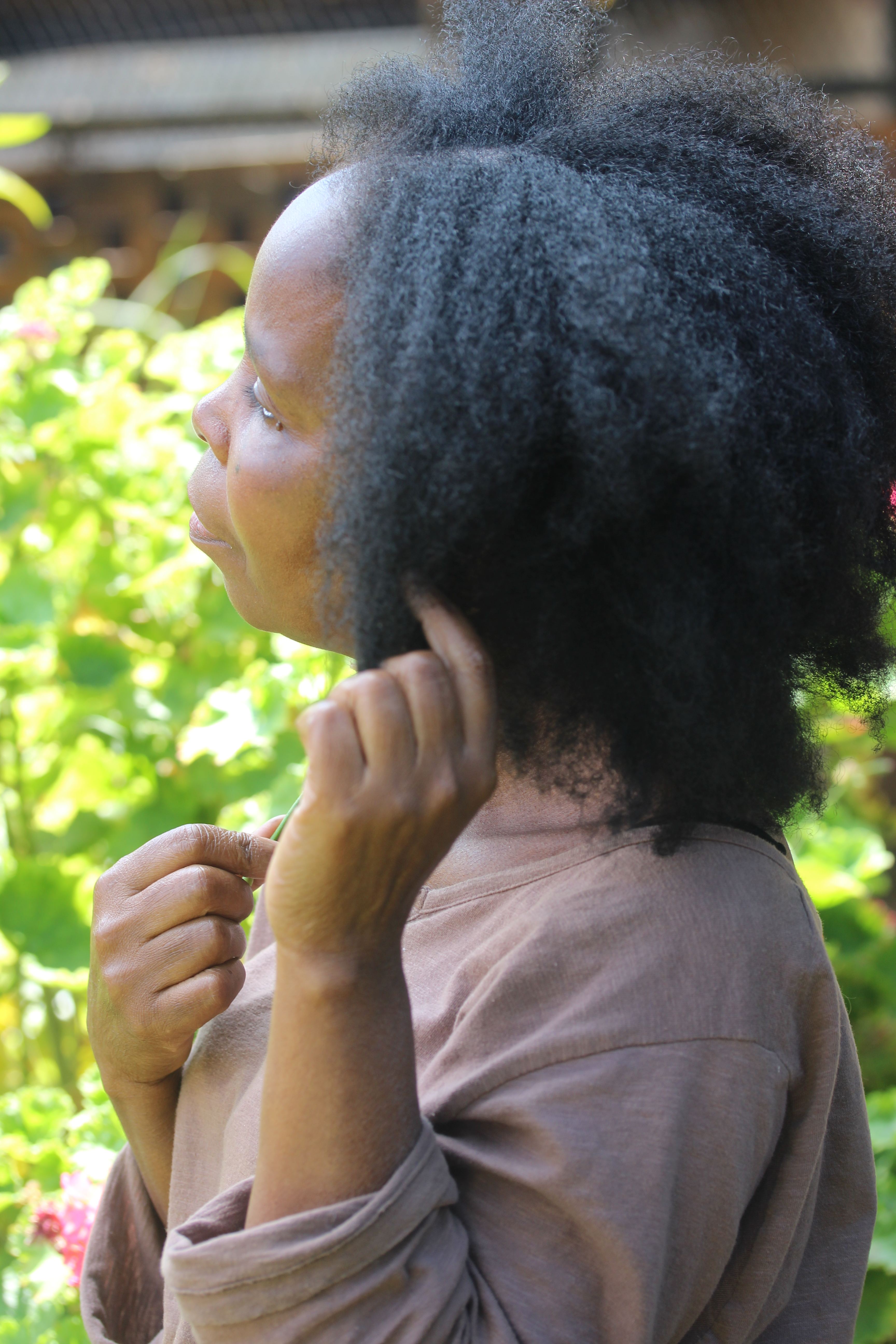 Woman showing her long natural hair outdoors