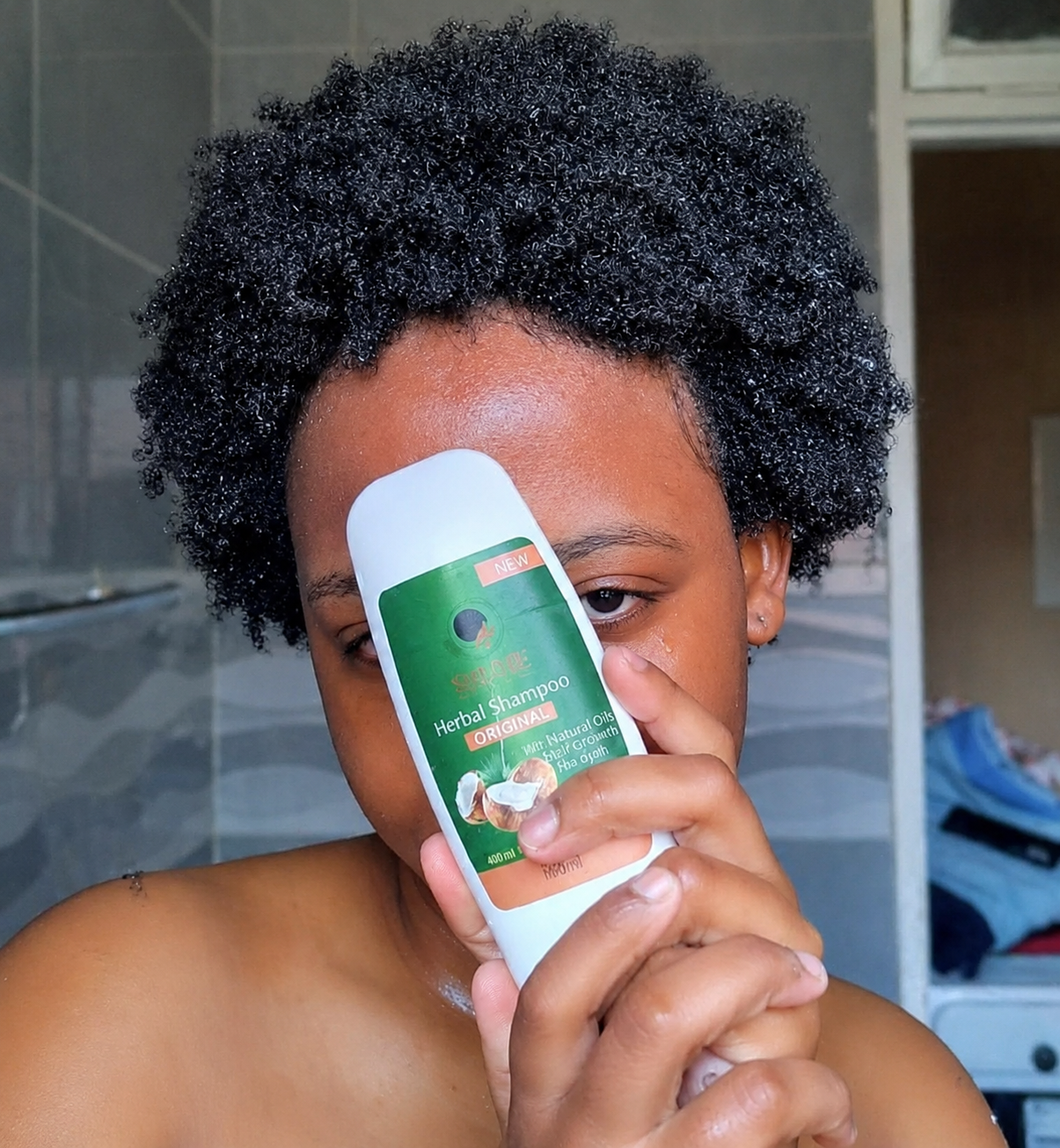 Shumie herbal shampoo held up as part of a washday routine